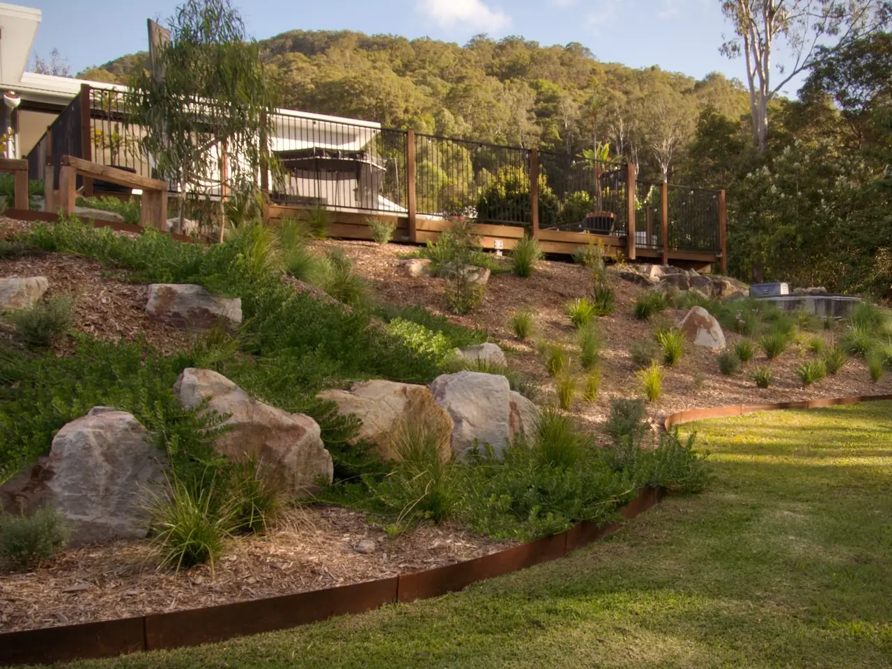 Established private garden with native planting, sandstone and mown lawn