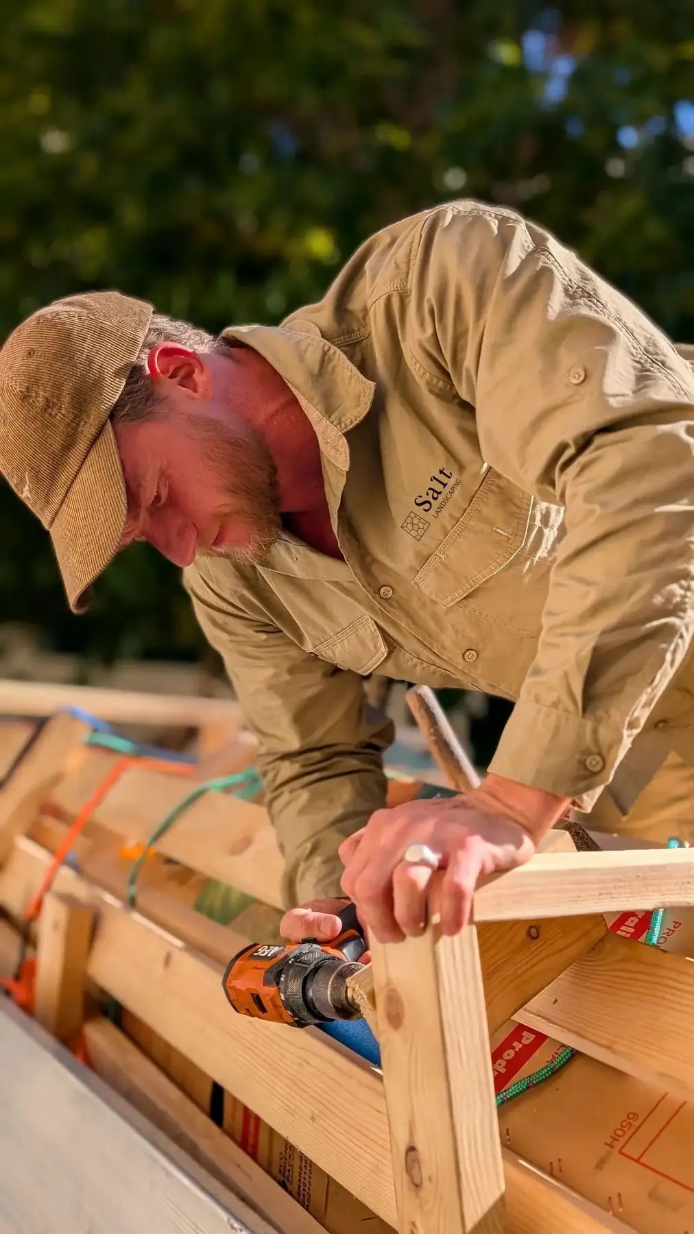 Travis from Salt Landscaping building a timber frame on site